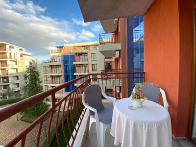 a balcony with a table and chairs on a balcony at ANITA A 25 Apartment Pool View SUNNY BEACH in Sunny Beach