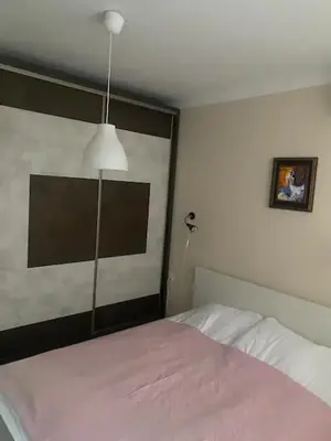 a bedroom with a bed with a large headboard at Pomorie residence 2-bedroom apartment 300m to the beach in Pomorie
