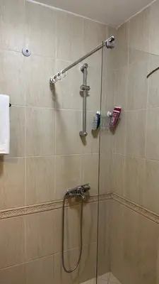 a shower with a glass door in a bathroom at Pomorie residence 2-bedroom apartment 300m to the beach in Pomorie