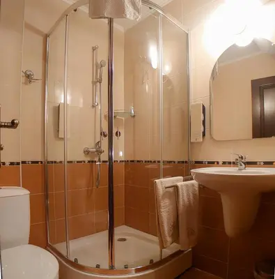 a bathroom with a shower and a toilet and a sink at Helios 350m from the beach in Sveti Vlas