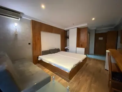 a bedroom with a bed and a couch in it at SAPPHIRE 202 Studio Sunny Beach in Sunny Beach