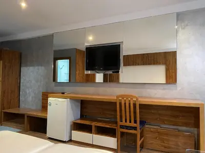 a kitchen with a counter with a tv and a refrigerator at SAPPHIRE 202 Studio Sunny Beach in Sunny Beach