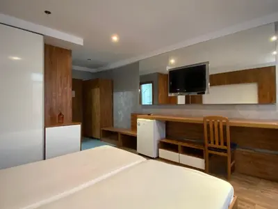 a bedroom with a bed and a tv on the wall at SAPPHIRE 202 Studio Sunny Beach in Sunny Beach