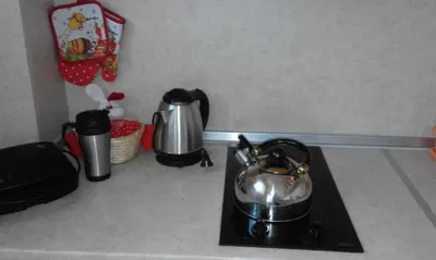 a stove top with a tea pot on top of it at Apartments Sea Sounds in Pomorie