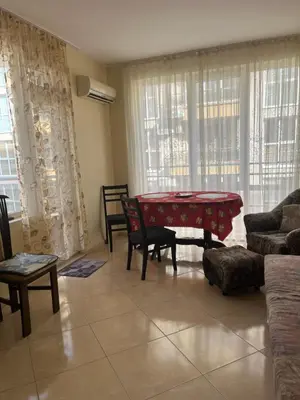 a living room with a red table and chairs at Apartments Sea Sounds in Pomorie