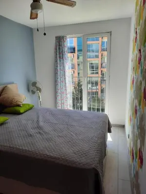 a bedroom with a bed and a large window at Spokojne wakacje w Bułgarii in Sunny Beach