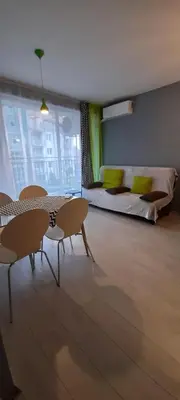 a living room with a table and chairs and a bed at Spokojne wakacje w Bułgarii in Sunny Beach