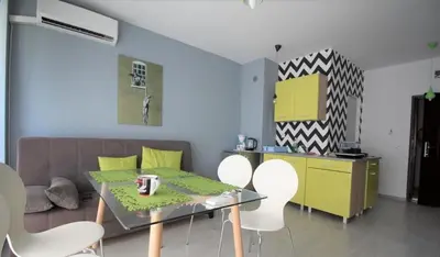a living room with a table and chairs and a couch at Spokojne wakacje w Bułgarii in Sunny Beach