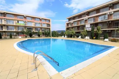 a large swimming pool in front of a building at Holiday-Orchid Menada Apartments in Sunny Beach