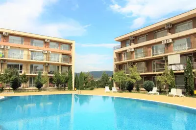 a large swimming pool in front of a building at Holiday-Orchid Menada Apartments in Sunny Beach