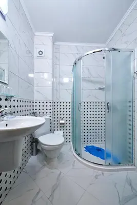 a bathroom with a shower and a toilet and a sink at Студио Патрисия in Pomorie