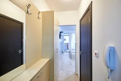 a bathroom with a black door and a phone at Студио Патрисия in Pomorie