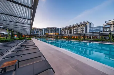 a swimming pool with lounge chairs in a building at Voya Beach Resort - Ultra All Inclusive in Sveti Vlas