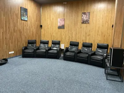 a waiting room with leather chairs and wooden walls at City view in Residences in Burgas City