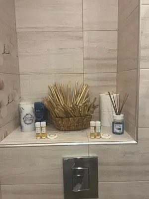 a shelf with candles and a basket on it at Къмпинг градина луксозен апартамент in Chernomorets