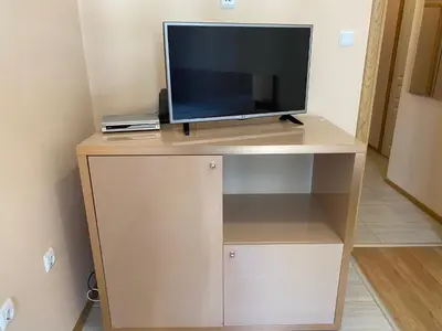 a tv sitting on top of a stand in a room at MESSEMBRIA A309 Studio Sunny Beach in Sunny Beach