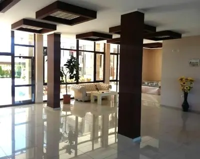 a lobby with a couch and a table in a building at Victoria's apartments Nesebar in Nesebar