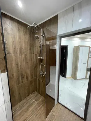 a bathroom with a shower and a mirror at Apartament deluxe Karina-Free parking in Burgas City