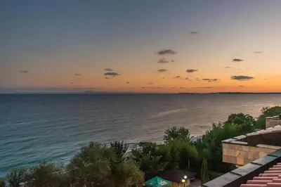 a view of the ocean at sunset at Tiva del Mar Beach Hotel in Sveti Vlas