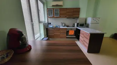 a kitchen with wooden cabinets and a counter top at Minimalistic 1BR flat with a Parking spot in Varna City