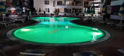 a large pool with green water in a building at Central Plaza - Studio - Sunny Beach in Sunny Beach