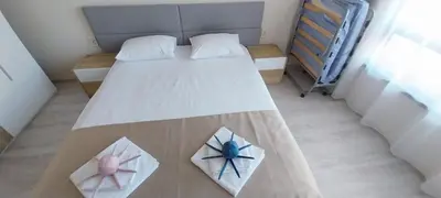 a small bedroom with a bed with two flowers on it at Sea Dreams Apartment in Sveti Vlas