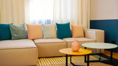 a living room with a couch and a table at Апартамент Жасмин с частен гараж - Jasmin Apartment with private garage in Varna City