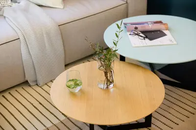 a table with a vase on it with two tables at Апартамент Жасмин с частен гараж - Jasmin Apartment with private garage in Varna City