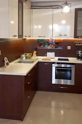a kitchen with a sink and a stove top oven at Апартамент Адикт in Sozopol