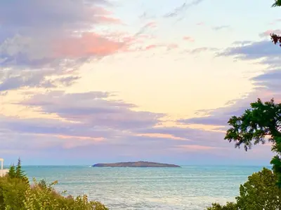 an island in the ocean under a cloudy sky at Apartments in complex PANORAMA in Chernomorets