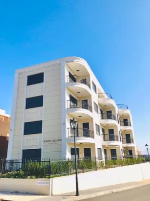 a white apartment building with a fence in front of it at Apartments in complex PANORAMA in Chernomorets