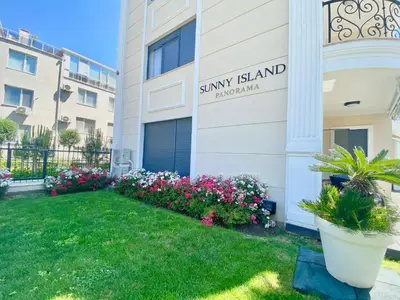 a building with flowers in front of a building at Apartments in complex PANORAMA in Chernomorets