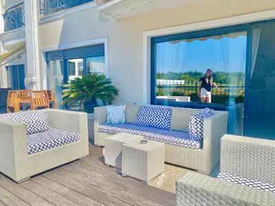 a patio with couches and tables on a porch at Apartments in complex PANORAMA in Chernomorets