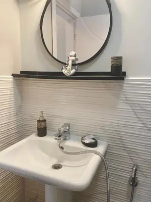 a bathroom with a sink and a mirror at Apartments in complex PANORAMA in Chernomorets
