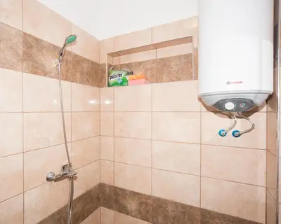 a bathroom with a shower with a shower head at Best Price - Downtown Flat in Burgas City