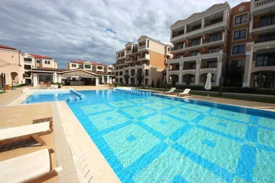 a large swimming pool in front of some buildings at Green Life Beach Resort Apartment in Sozopol