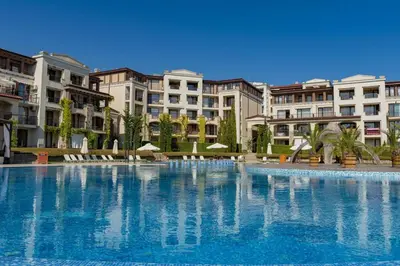 a large swimming pool with buildings in the background at Green Life Beach Resort Apartment in Sozopol