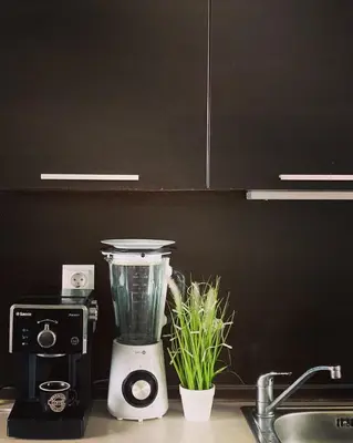 a blender sitting on a kitchen counter next to a sink at Atlantis Resort Sea View in Burgas City