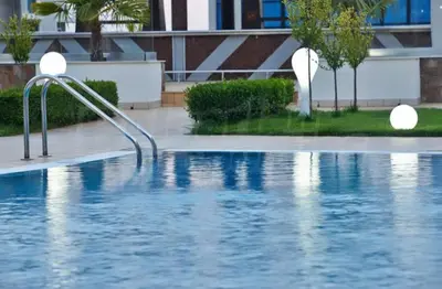 a swimming pool in front of a building at Atlantis Resort Sea View in Burgas City
