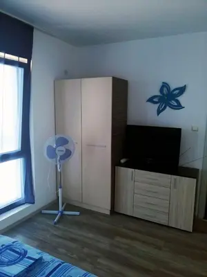 a room with a bedroom with a bed and a tv at Private apartment with sea view in Blue Bay Pallace in Pomorie