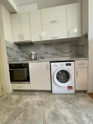 a kitchen with a washing machine and a sink at Marea Garden apartments in Ravda