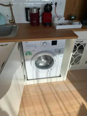 a washing machine in a kitchen under a counter at CASA VISTA in Burgas City