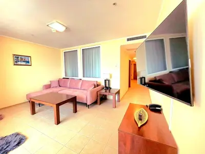 a living room with a pink couch and a table at 