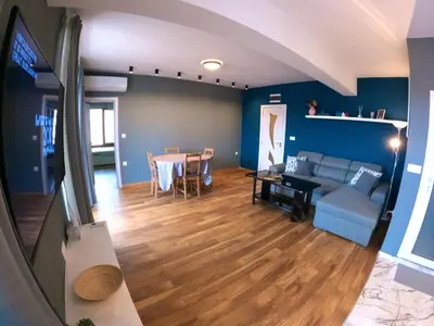 a living room with a couch and a table at Dune Apartment Nessebar in Nesebar