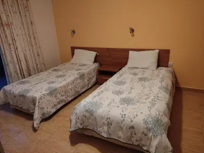 two beds sitting in a room with at Dean's Cozy 2 Bed Apart at Sunny Beach resort in Sunny Beach