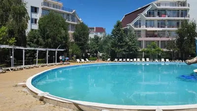 a large swimming pool in front of a building at Dean's Cozy 2 Bed Apart at Sunny Beach resort in Sunny Beach