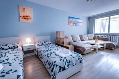 a living room with two beds and a couch at Daisy - 3 Room and kitchen apartment in Lazur in Burgas City