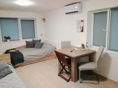 a room with a bed and a table with a desk at Болярска10 in Burgas City