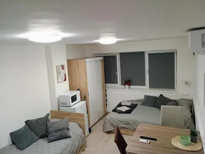 a small room with a bed and a table at Болярска10 in Burgas City