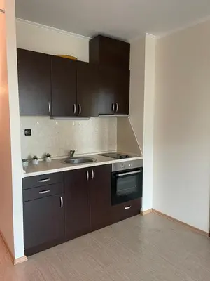 a kitchen with dark brown cabinets and a sink at Babylon SP apartment 56 in Sunny Beach